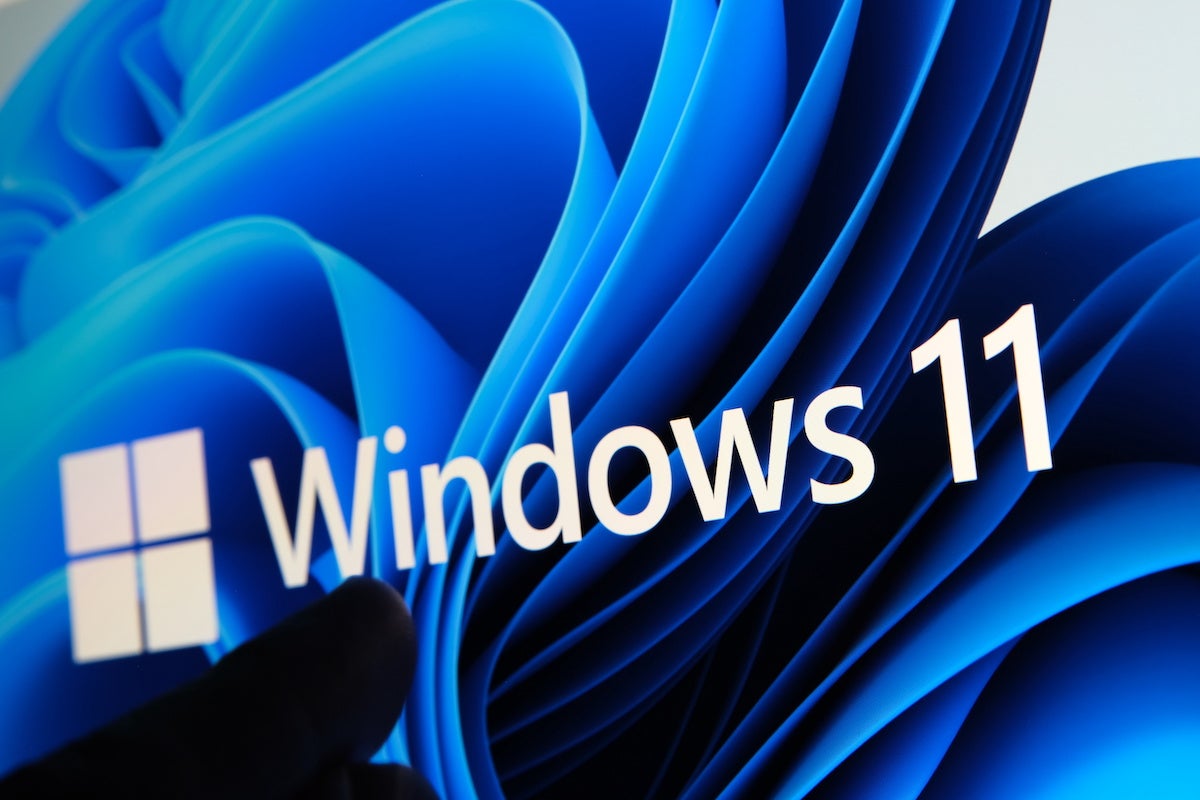 Windows 11 Logo Seen on the Screen of Tablet and User Pointing at It with Finger. Stafford, United Kingdom, July 1, 2021