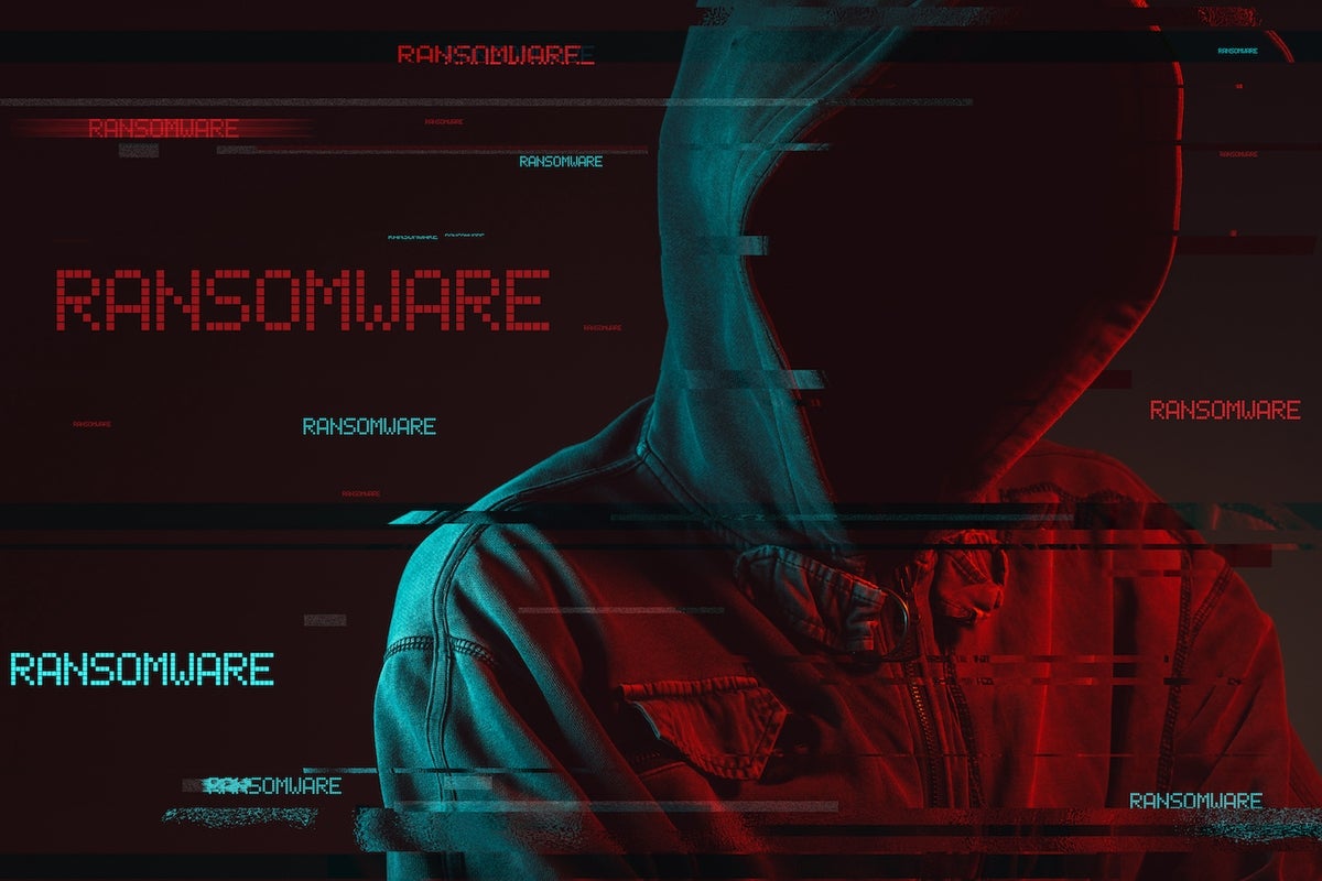 Ransomware Concept with Faceless Hooded Male Person, Low Key Red and Blue Lit Image and Digital Glitch Effect